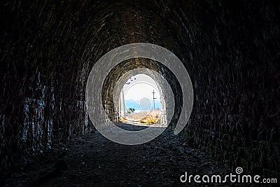 Exit from the dark railway tunnel. A light in the end of a tunnel Stock Photo