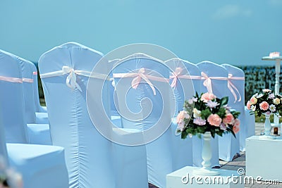 Exit registration of the newlyweds, wedding ceremony under open sky. Seating guests. Rows of chairs with white capes, close up Stock Photo