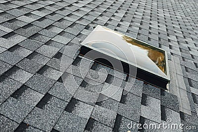 exit roof window on shingles flat polymeric roof-tiles Stock Photo