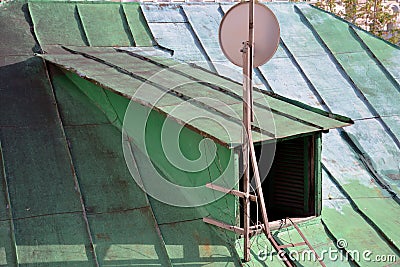Exit to old green metal roof with antenna Stock Photo