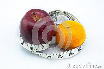 Exotic Apple and Orange being surrounded by measure tape Stock Photo