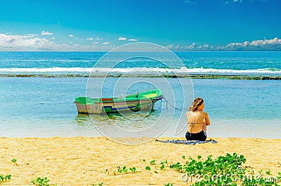 Exotic beach, young girl, fishing boat and water Editorial Stock Photo