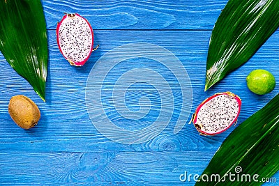 Exotic fruit meal. Dragonfruit, kiwi, lime on blue wooden table background top view copyspace Stock Photo