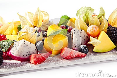 Exotic Fruit Plate or Vegan Platter with Sliced Fruits and Berries Stock Photo