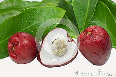 Exotic fruit Syzygium malaccense with leaves and one cut in white background Stock Photo