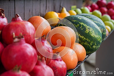 Exotic fruits arranged on a fresh stand.Focus on grapefruit. Stock Photo