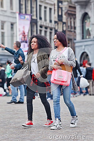 Exotic girls walk at Dam Square, Amsterdam, Netherlands Editorial Stock Photo