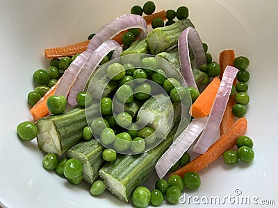 Exotic salad with drumsticks green peas carrots and onion rings Stock Photo