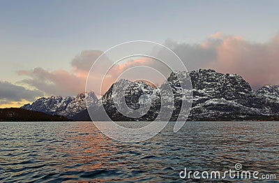 Expansive fjord in the Lofoten Islands surrounded with snowy mountains and a colorful winter sunset. Norway. Stock Photo