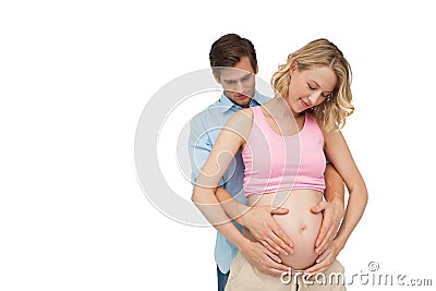 Expectant happy parents holding mothers baby bump Stock Photo