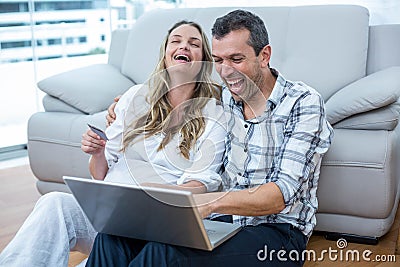 Expecting couple sitting on floor Stock Photo