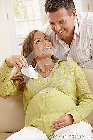 Expecting parents with baby shoes Stock Photo