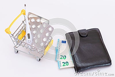 Pills and Capsules in a Shopping Cart and Black Wallet with Euro Money Stock Photo