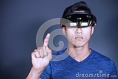 Experience VR hololens headset in studio with advanced technology. Body gesture when using virtual reality glasses Stock Photo