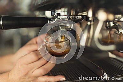 Closeup of barmen hand brewing espresso in professional coffee machine Stock Photo