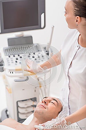 Experienced cosmetologist undergoing electroporation treatment Stock Photo