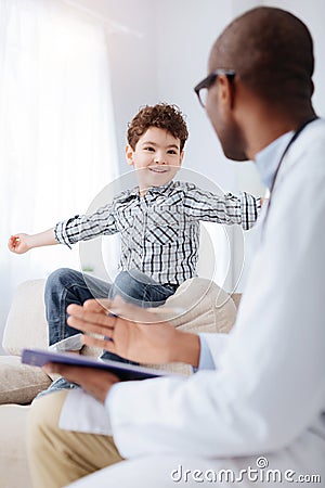 Experienced male doctor listen to boy Stock Photo
