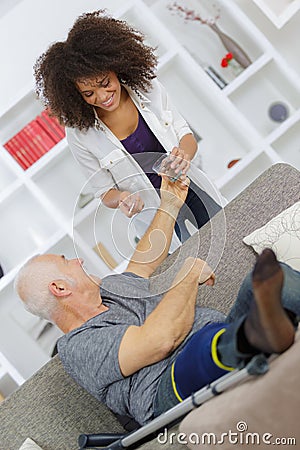 Experienced physician assisting senior man in recovery process Stock Photo