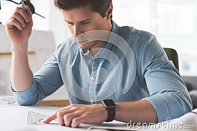 Experienced pleasant man is laboring with concentration Stock Photo