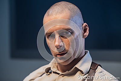 An experienced police officer poses for a photo at a police station Stock Photo