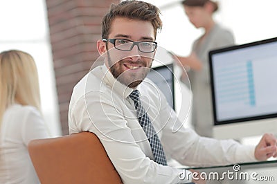Experienced programmer sitting in front of the monitor. Stock Photo