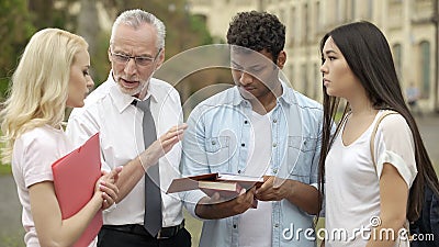 Experienced teacher talking with students about future scientific research Stock Photo