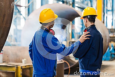 Expert checking the quality of manufactured boilers Stock Photo