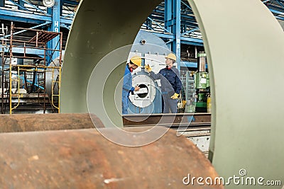 Expert checking the quality of manufactured boilers Stock Photo