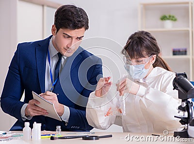 Expert criminologist working in the lab for evidence Stock Photo