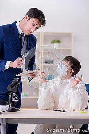 The expert criminologist working in the lab for evidence Stock Photo