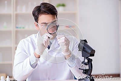 The expert criminologist working in the lab for evidence Stock Photo