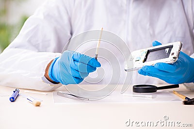 Male expert criminologist working in the lab for evidence Stock Photo