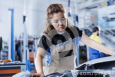 Expert examines faulty car motor Stock Photo