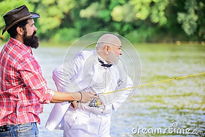 Expert fisherman. Bearded man elegant businessman fish together. Learn to fish. Fishing skills. Fish with companion who Stock Photo