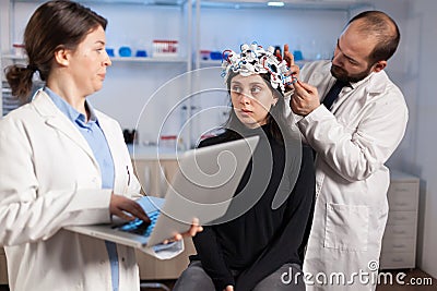 Expert medic in neuroscience developing brain experiment holding laptop Stock Photo