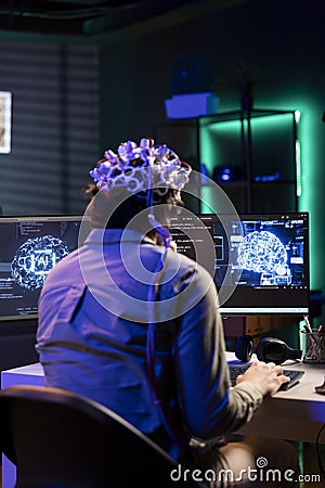 IT expert using neuroscience and EEG headset to gain digital soul Stock Photo