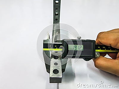 An expert is using a Vernier tool to check the scale of the workpiece. for accuracy to meet quality standards Stock Photo