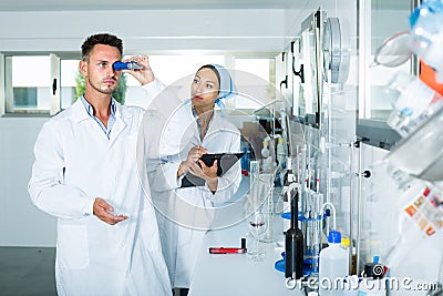 experts making tests in winery laboratory. Stock Photo