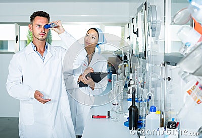 experts making tests in winery laboratory. Stock Photo