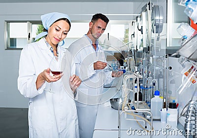 experts making tests in winery laboratory. Stock Photo