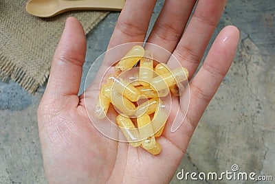 Expired Vitamins Characteristics of expired vitamins The capsules inside the water form hard, lumpy, inedible. Stock Photo