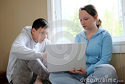 explain lesson boy showing girl on computer helping study friends older brother younger sister online learning spending Stock Photo