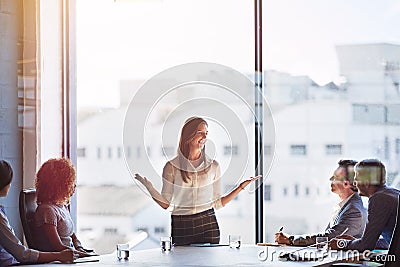 Explaing her ideas in detail. businesspeople having a meeting in a boardroom. Stock Photo