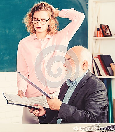 Explaining difficult topic. Student puzzled by some information. Student asking teacher about task. Solving math tasks Stock Photo