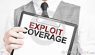 EXPLOIT COVERAGE inscription on a notebook in the hands of a businessman on a gray background, a man points with a finger to the Stock Photo