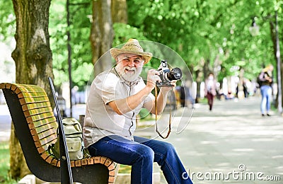 Explore city. Tourism hobby. Tourist concept. Travel and tourism. Photographer sit on bench in park. Capturing spring Stock Photo