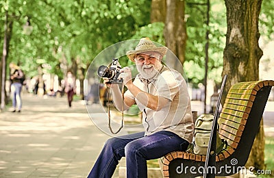 Explore city. Tourism hobby. Tourist concept. Travel and tourism. Photographer sit on bench in park. Capturing spring Stock Photo