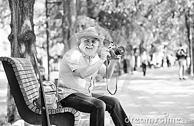 Explore city. Tourism hobby. Tourist concept. Travel and tourism. Photographer sit on bench in park. Capturing spring Stock Photo