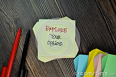 Explore Your Options write on sticky note isolated on Wooden Table Stock Photo