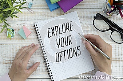 Explore Your Options write on sticky note isolated on Wooden Table. Stock Photo